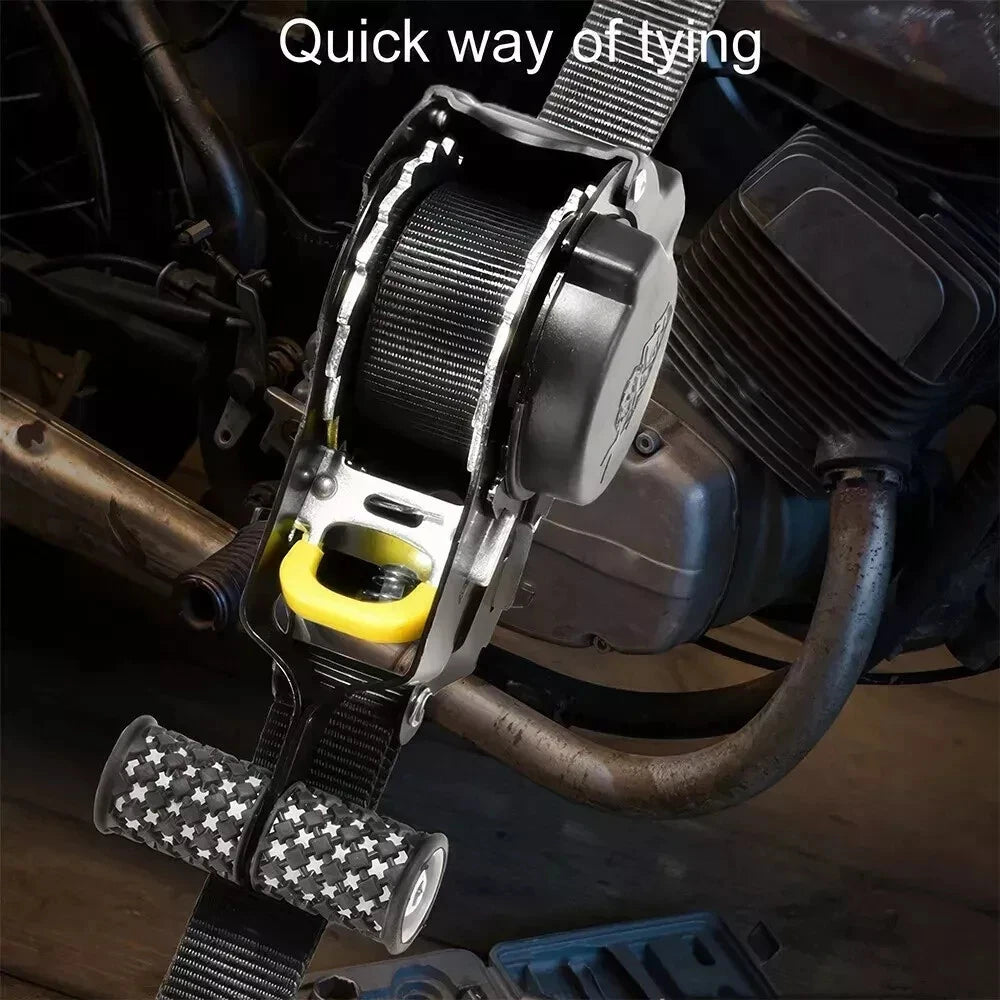 Motorcycle tie-down strap with auto retractable quick-release mechanism on a vehicle.